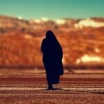 silhouette of person walking on ground at daytime